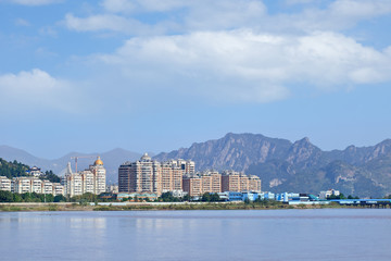 Luxury apartment buildings with river view near mountain ridge, Wenzhou, Zhejiang Province, China