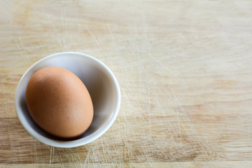 Fresh Egg With Bowl of Egg White on Wooden Table, Food Rustic Style.
