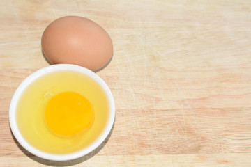 Fresh Egg With Bowl of Egg White on Wooden Table, Food Rustic Style.