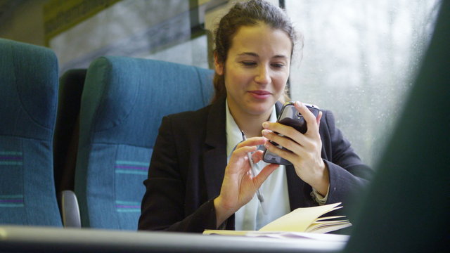  Confident businesswoman on mobile phone on a train