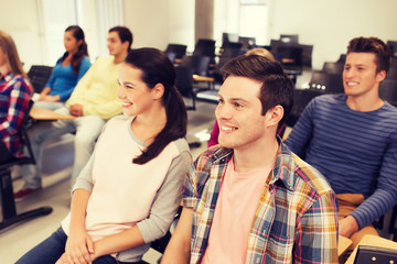 group of smiling students in lecture hall