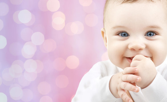 happy baby over pink lights background