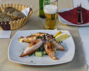 Grilled squid. Meal with beer glass in a restaurant