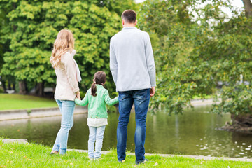 family walking in summer park