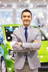 happy man at auto show or car salon