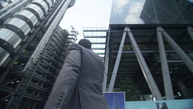  London businessman talking on smartphone punches the air having just clinched a deal. EDITORIAL.