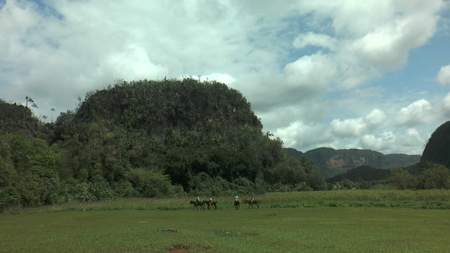 riders in idyllic landscape vinales valley in cuba