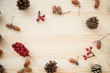Christmas frame: cones, cinnamon, berries, acorn on the wood table