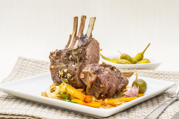 Grilled rack of lamb with carrot, garlic