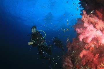 Fototapeta na wymiar Scuba diver explores coral reef