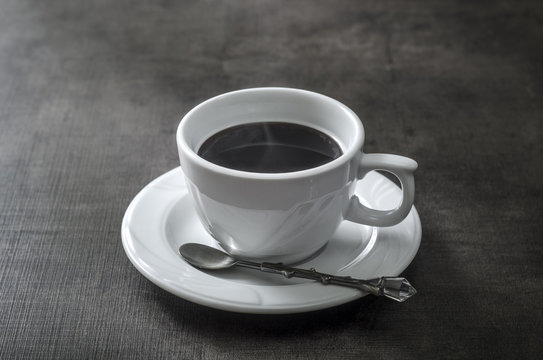Cup of coffee on wooden  dark table
