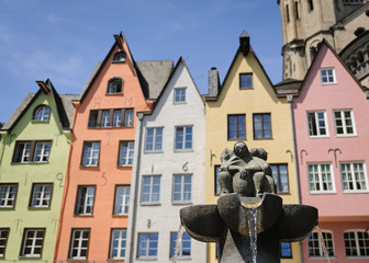Fountain near the colorful houses in the old center of Cologne, Germany