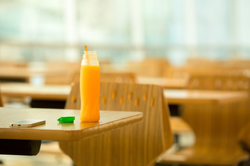 Bottle of orange juice on table.