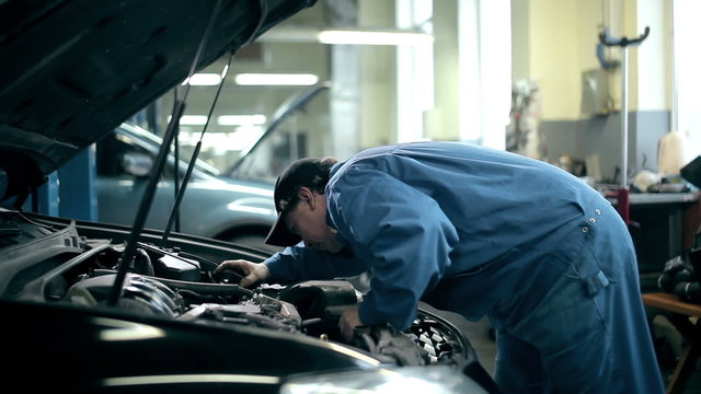 Mechanic inspecting the car engine