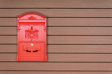 Red mailbox with wooden background with copy space