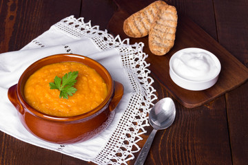 Pumpkin soup on wooden table