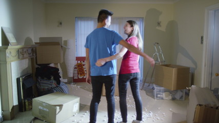  Happy affectionate young couple embrace in their new home