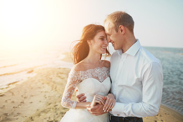 Just married couple running on a sandy beach