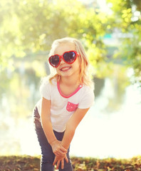 Happy smiling child wearing a sunglasses having fun in summer da