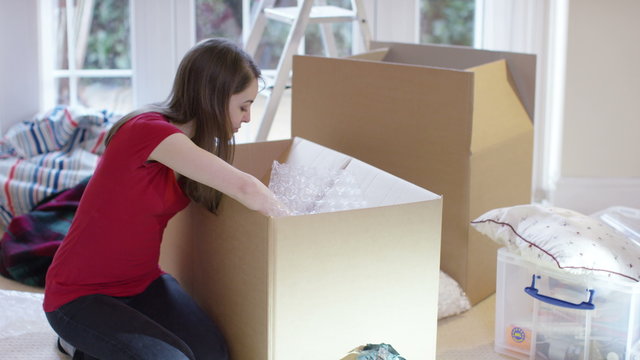  Happy young couple unpacking boxes, moving into new home