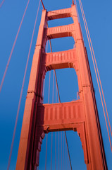 View of the south tower of the Golden Gate Bridge from the walkway. The famous Art Deco landmark is painted orange to enhance its visibility in fog. - 97820847
