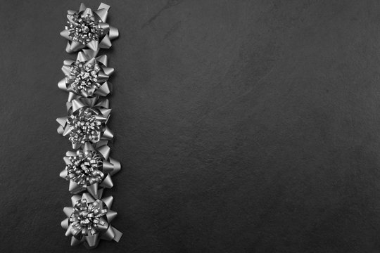 Pewter/silver Bows On A Slate Background