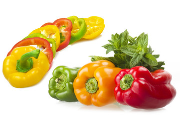 colored peppers close up over white background