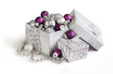 Silver and purple Christmas ornaments in gift box