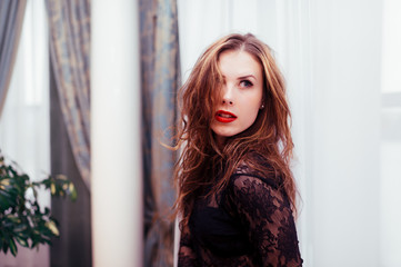 Sexy lady with long hair top in classical glamour interior