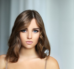 Fototapeta premium Portrait of a young blond girl with blue eyes