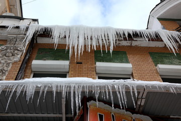 icicles which are hanging down from a roof.