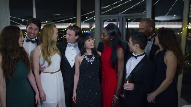  Portrait of attractive mixed ethnicity group of friends at glamorous party