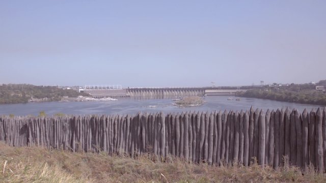 View of the hydroelectric power plant due to the stockade Zaporozhye Sech from the island Khortytsya. Ukraine