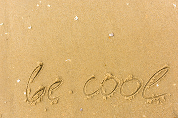 Be cool written on the beach sand