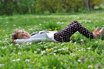 Girl lying on grass in springtime