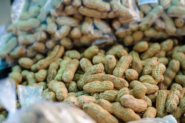 Heap of raw peanuts in shell at stand for sale