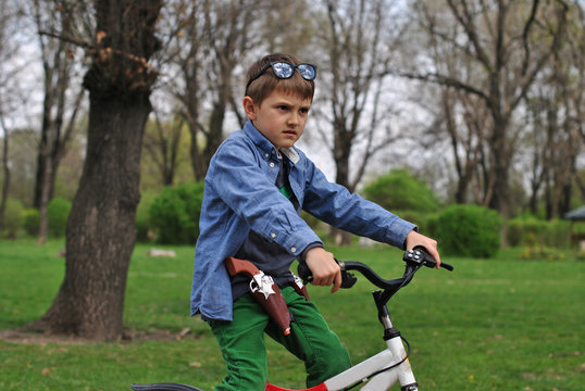 Boy pretending to be a policeman on a bike
