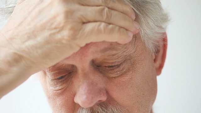closeup view of senior man with head pain