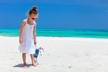 Little girl with toy at beach