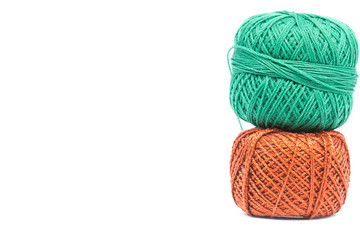 Orange and green cotton crochet. Isolated on white background.