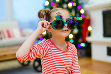 Little girl wearing funny Christmas glasses