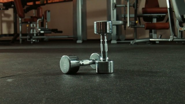 two dumbbells in gym