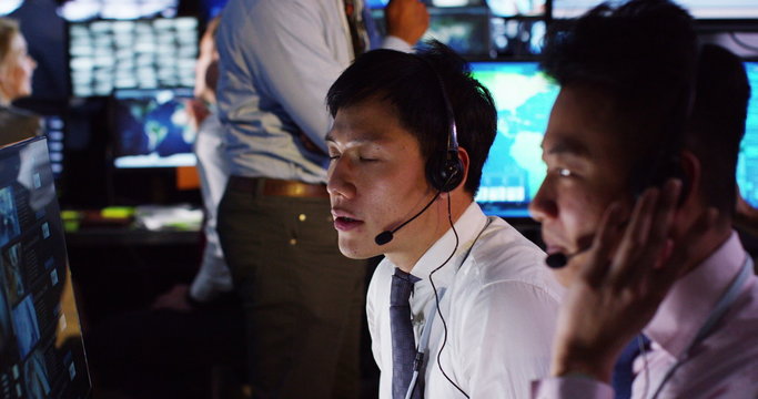  Security & surveillance team working in a busy system control room.