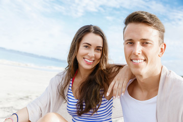 Romantic young couple sitting on the beach