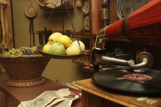 Vintage style retro room with fruit basket, gramophone and old money