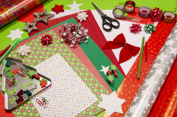Arts and craft supplies for Christmas. Colorful wrapping paper rolls, pencils, different washi tapes, craft scissors. Wrapping Christmas gifts in colorful paper.