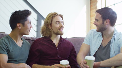 Young people socialising together and having fun over a coffee