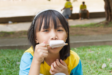 Fototapeta premium Cute Toddler Girl Eating Ice-Cream
