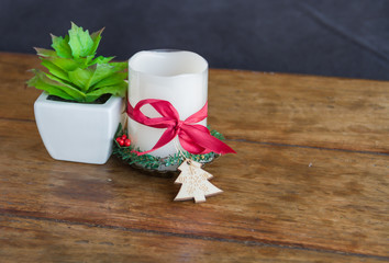 Candles decorated for Christmas on wooden table