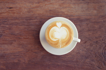 Close up cup of Coffee, latte on the wooden table - Vintage Filter Effect
